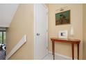 Hallway with simple staircase, complemented by a charming wooden console table and elegant artwork at 145 15Th Ne St # 1225, Atlanta, GA 30309
