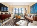 Inviting living room with modern decor, a large flat-screen TV, and panoramic outdoor views at 145 15Th Ne St # 1225, Atlanta, GA 30309