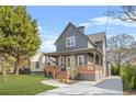 Charming two-story home features a welcoming front porch, manicured lawn, and a modern gray exterior at 3378 Bachelor St, Atlanta, GA 30344