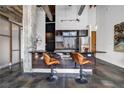 Modern kitchen with black island and bar seating, stainless steel appliances, and exposed concrete beams at 650 Glen Iris Drive Ne # 27, Atlanta, GA 30308