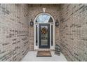 Close-up of the front door showcasing sidelights, decorative wreath, and brick facade at 1657 Williams Mill Way, Dacula, GA 30019