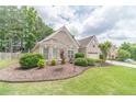 Charming brick home featuring a well-manicured lawn and an attached two-car garage at 1657 Williams Mill Way, Dacula, GA 30019
