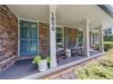 Inviting front porch with classic rocking chairs, decorative plants, and charming details at 1890 Silvastone Dr, Decatur, GA 30033