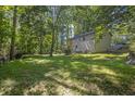 Expansive backyard with mature trees offering shade and privacy, perfect for outdoor activities and relaxation at 3189 Glen Hollow Dr, Rex, GA 30273