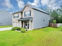 Two-story home showcasing a brick front and siding on the side, plus a lovely yard at 201 Kingfisher Walk, Covington, GA 30014