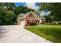 Spacious home with a large driveway, two-car garage and a well-kept lawn at 2430 Harbin Springs Cv, Dacula, GA 30019