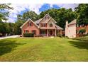 Beautiful two-story home with lush green lawn and well-maintained landscaping at 2430 Harbin Springs Cv, Dacula, GA 30019
