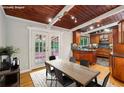 Bright dining area featuring french doors, a view of the back yard, and access to the kitchen at 3539 Eaglerock Dr, Doraville, GA 30340