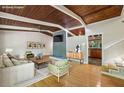 Bright living room with wood floors, high ceilings, fireplace, and view into updated kitchen at 3539 Eaglerock Dr, Doraville, GA 30340