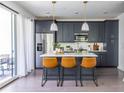 Modern kitchen with stainless steel appliances, center island, and bar stool seating at 399 Pratt Se Dr # 910, Atlanta, GA 30315