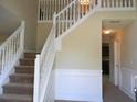 Inviting foyer with staircase, white railings, and view into adjacent room at 5622 Platte Dr, Ellenwood, GA 30294