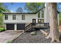 Charming split-level home with black trim, an inviting entryway, and a well-maintained yard at 104 River Creek Dr, Woodstock, GA 30188