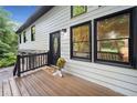 Inviting front porch with a decorative front door and black accents that complement the updated exterior at 104 River Creek Dr, Woodstock, GA 30188
