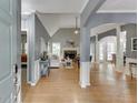Inviting foyer flowing into the living and dining areas featuring hardwood floors and a stone fireplace at 1045 Legacy Walk, Woodstock, GA 30189
