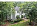 View of rear exterior showing walkout basement access and mature trees at 1763 Benningfield Sw Dr, Marietta, GA 30064