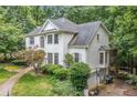 Rear exterior of the home featuring brick and siding with a screened in porch at 1763 Benningfield Sw Dr, Marietta, GA 30064