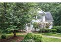 Home exterior surrounded by lush trees and colorful landscaping at 1763 Benningfield Sw Dr, Marietta, GA 30064