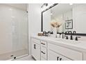 Bright bathroom with double vanity, sleek black faucets, and a glass-enclosed shower at 1923 Deco Dr, Kennesaw, GA 30144