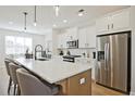 Bright, modern kitchen featuring stainless steel appliances, island with seating, and white cabinetry at 1923 Deco Dr, Kennesaw, GA 30144
