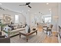 Comfortable living room with fan, neutral colors, wood floors, and view into the kitchen at 1923 Deco Dr, Kennesaw, GA 30144