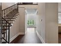 Spacious foyer with wood floors and staircase leading to the upper level at 3280 Stillhouse Se Ln # 401, Atlanta, GA 30339
