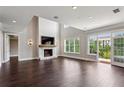 An airy living room with hardwood floors, fireplace, and balcony access at 3280 Stillhouse Se Ln # 401, Atlanta, GA 30339