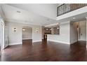 Large open-concept living room with dark wood floors, recessed lighting, and neutral walls at 3280 Stillhouse Se Ln # 401, Atlanta, GA 30339