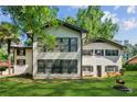 Inviting home exterior, featuring a lush backyard, a blend of textures and ample natural light at 3425 Poplar Dr, Lawrenceville, GA 30044