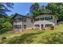 Classic home featuring a well-maintained lawn, dark trim, and ample natural light through numerous windows at 3425 Poplar Dr, Lawrenceville, GA 30044