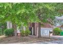 Charming brick home featuring a two-car garage and a neatly maintained front yard at 7078 Ravenwood Ln, Lithonia, GA 30038