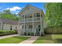 Charming two-story home featuring double porches, well-manicured lawn and walkway leading to the front entrance at 1039 Fern Se Ave, Atlanta, GA 30315
