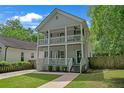 Charming two-story home featuring a double porch, freshly painted exterior, and manicured lawn at 1039 Fern Se Ave, Atlanta, GA 30315