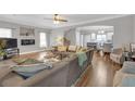 Spacious living room features hardwood floors, comfortable sectional seating, archway to kitchen, and neutral paint at 1039 Fern Se Ave, Atlanta, GA 30315