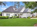 Beautifully landscaped home with a mix of siding and brick, complemented by lush greenery at 114 Karland Nw Dr, Atlanta, GA 30305