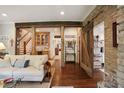 Inviting living room features hardwood floors, exposed beams, and a sliding barn door at 114 Karland Nw Dr, Atlanta, GA 30305