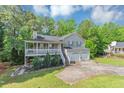 Charming home featuring a covered porch, two car garage and mature trees at 185 Wyngate Ct, Dallas, GA 30157