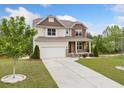 Traditional two-story home with a well-maintained lawn and a concrete driveway at 2889 Windsor Knoll Dr, Dacula, GA 30019