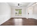 Bright living room with crown molding, wainscoting and hardwood floors at 2889 Windsor Knoll Dr, Dacula, GA 30019