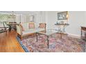 Sunlit living room with beautiful hardwood floors and view to adjacent dining room and kitchen at 3475 Oak Valley Ne Rd # 950, Atlanta, GA 30326