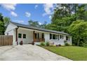 Renovated ranch-style home featuring a freshly painted white brick exterior and updated landscaping at 1477 Spruce Se Dr, Smyrna, GA 30080