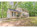 Side view of two-story home with attached garage and mature trees in a residential area at 205 N Fayette Dr, Fayetteville, GA 30214