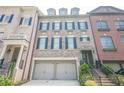 Beautiful townhome showcasing a two-car garage and classic black shutters at 2295 Falmouth Se Ct, Smyrna, GA 30080