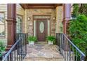 Inviting entryway features a stone walkway, covered porch, and a decorative front door at 3301 Chastain Ridge Dr, Marietta, GA 30066