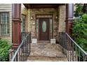 Stylish entryway with stone accents, a decorative front door with glass, and custom iron railings at 3301 Chastain Ridge Dr, Marietta, GA 30066