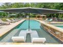 Backyard pool and spa area featuring loungers, a large umbrella and a covered cabana at 4135 Creekwood Dr, Cumming, GA 30041