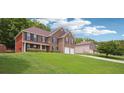 A two-story brick home featuring a lush lawn and an attached two-car garage at 4549 Clarks Creek Ter, Ellenwood, GA 30294