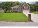 Beautiful two-story brick home features a manicured lawn and attached two-car garage at 4549 Clarks Creek Ter, Ellenwood, GA 30294