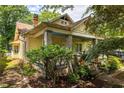 A well-maintained home featuring a manicured yard and a charming front porch with stone pillars at 1290 Mclendon Ne Ave, Atlanta, GA 30307