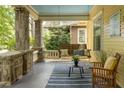 Relaxing front porch with comfortable seating, a swing, and stylish decor, perfect for enjoying the outdoors at 1290 Mclendon Ne Ave, Atlanta, GA 30307