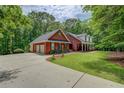 Brick home with attached garage, spacious driveway, and lush green lawn at 15 Walnut Ridge Way, Covington, GA 30014